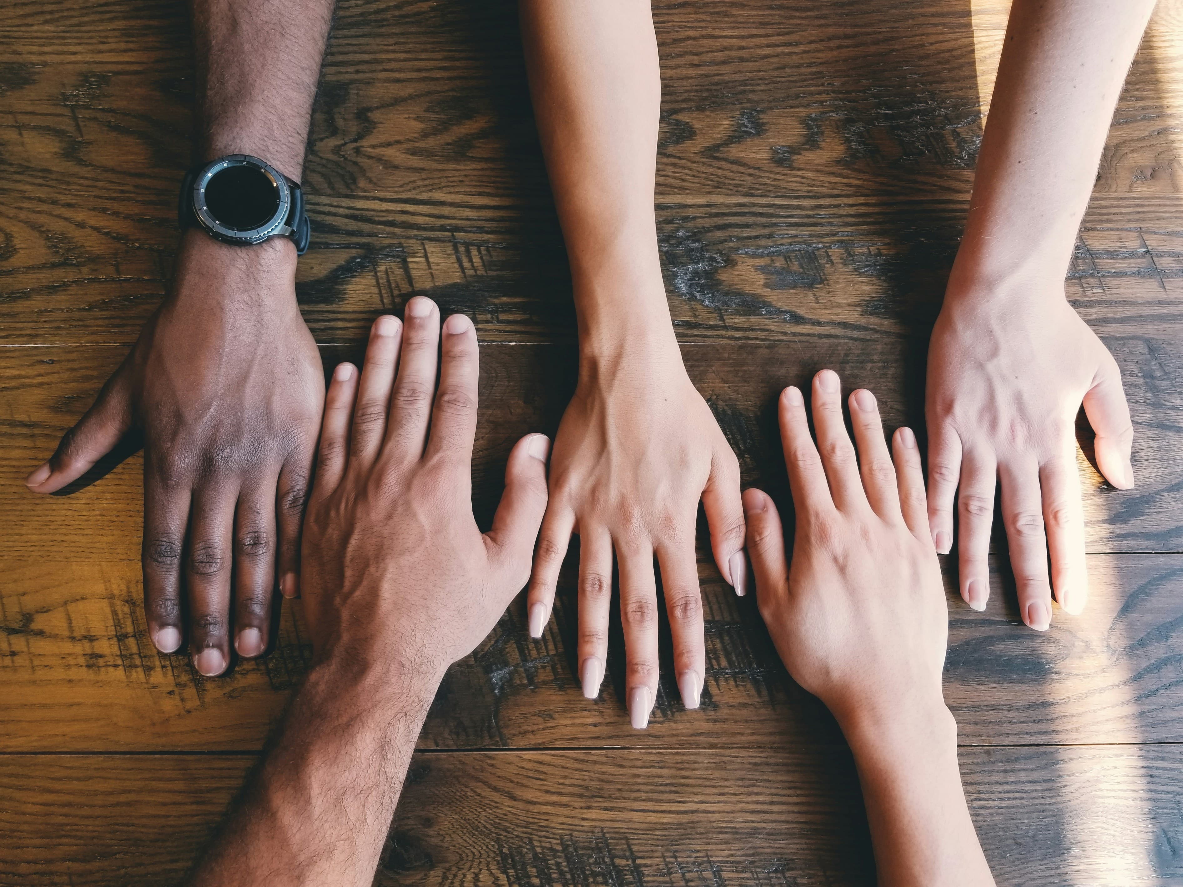 Hands joined together representing community organisations