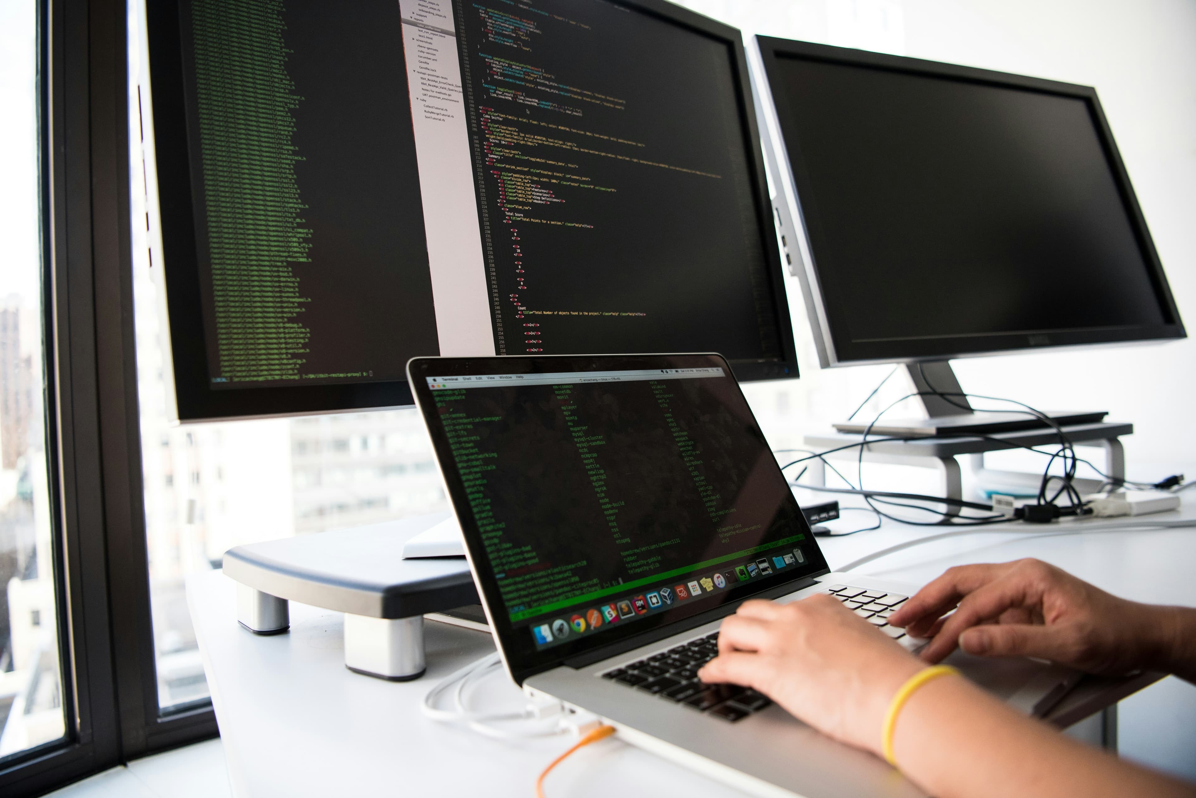A developer working across multiple screens