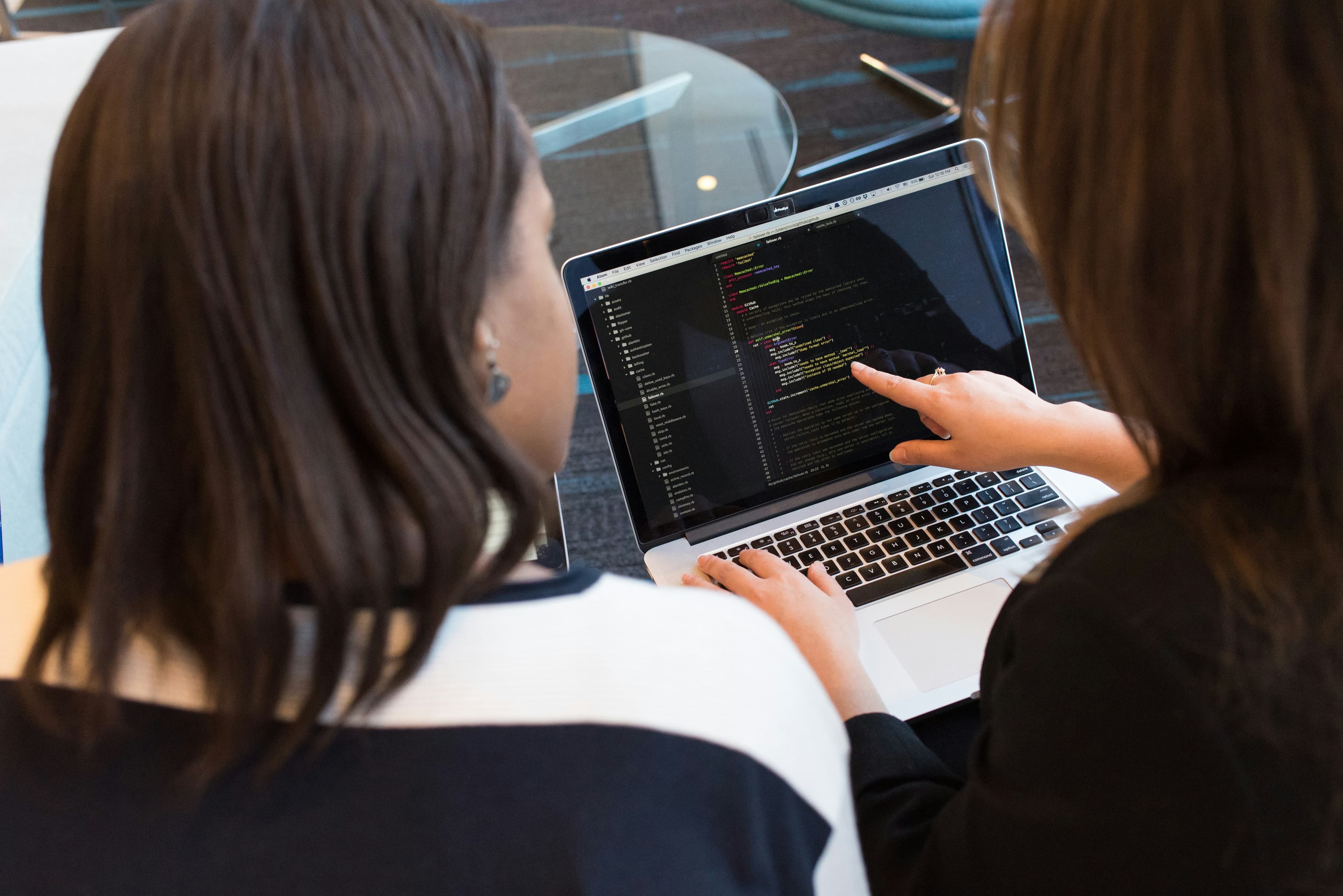 Two CYVRIX specialists reviewing technical work together on a laptop
