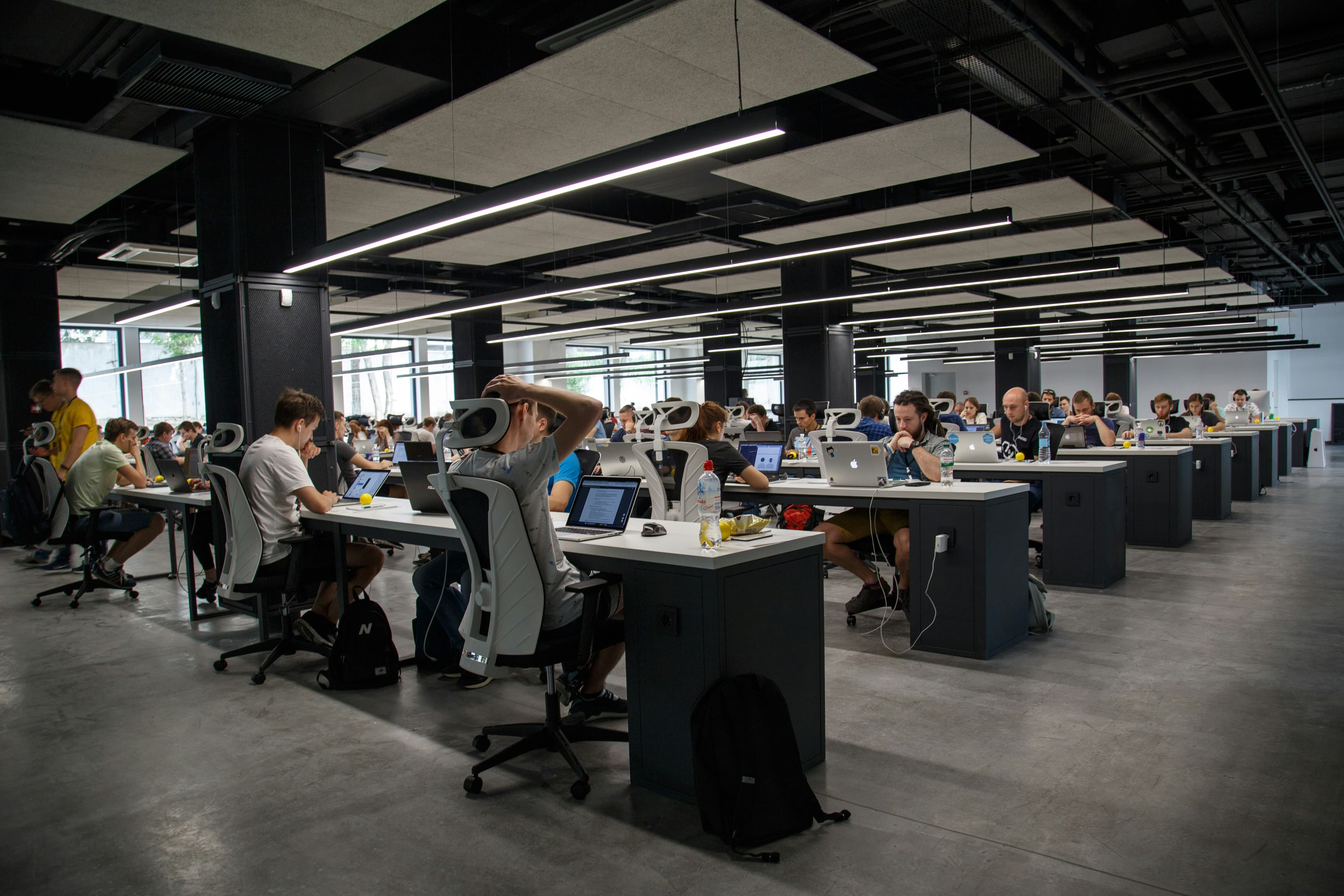Managed laptops in use across an open-plan office