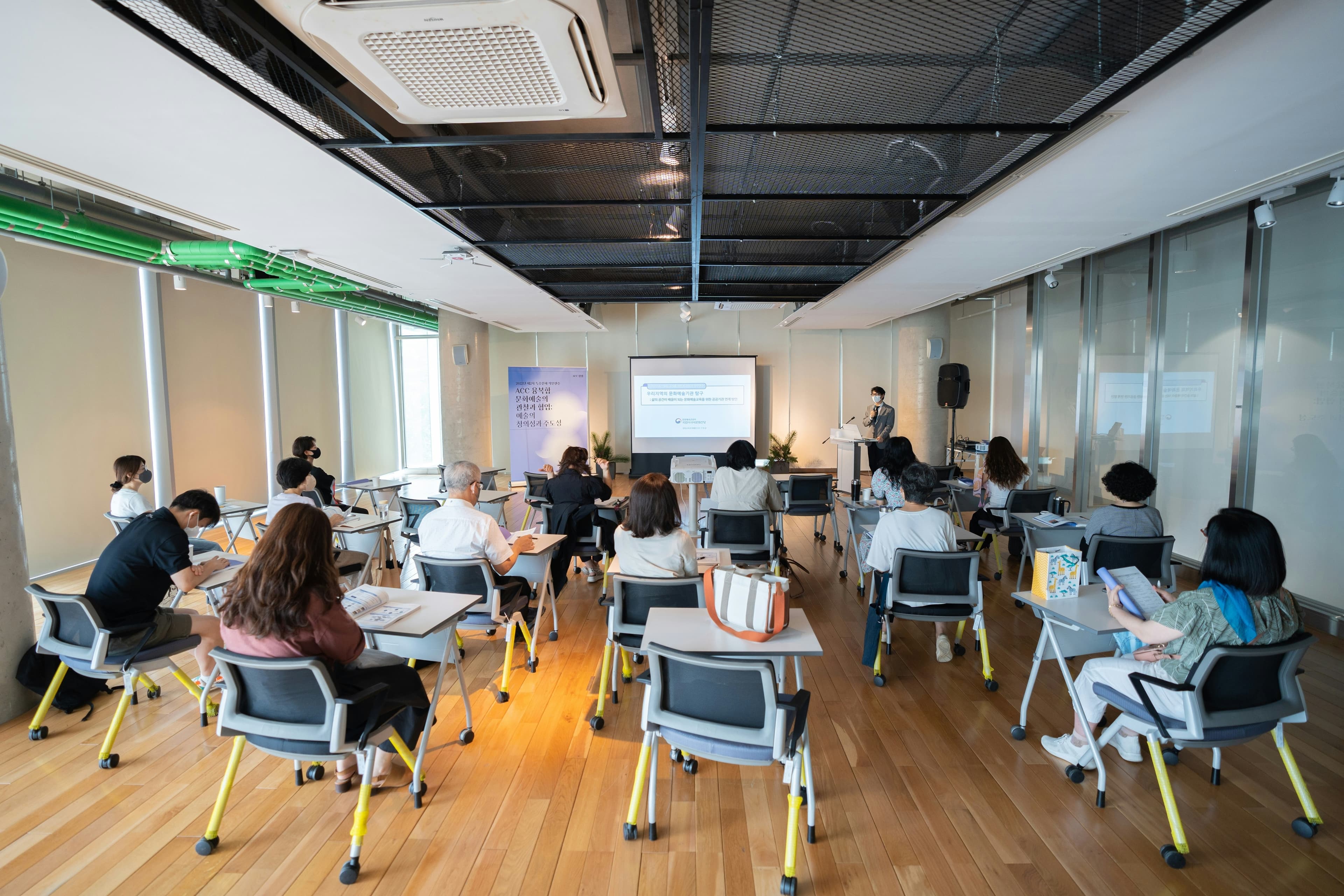 A classroom of learners working at desks